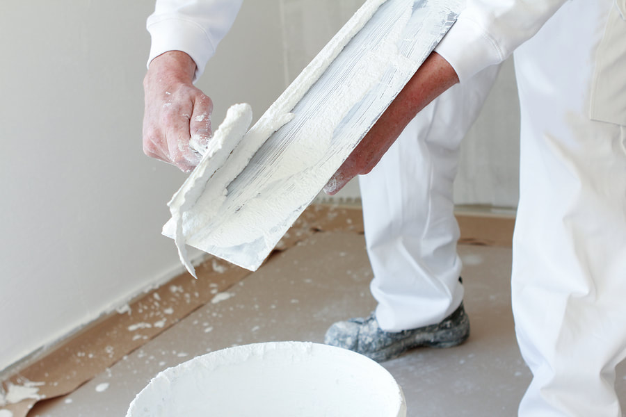man mixing plaster